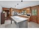 Bright kitchen featuring an island with quartz countertop, stylish pendant lights and stainless appliances at 3806 Sue Ln, Raleigh, NC 27604