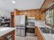 Modern kitchen featuring stainless steel appliances, island, and undermount sink by a large window at 3806 Sue Ln, Raleigh, NC 27604