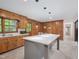 Bright kitchen featuring an island with quartz countertop, stylish pendant lights and stainless appliances at 3806 Sue Ln, Raleigh, NC 27604