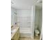 Bathroom featuring a tub-shower combo, and a modern toilet and sink at 409 Neathery St, Henderson, NC 27536