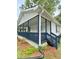 Charming home featuring a cozy front porch with blue accents and a well-maintained exterior at 409 Neathery St, Henderson, NC 27536