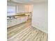 Kitchen featuring light-colored cabinets, modern floors and sink, and light-colored walls at 409 Neathery St, Henderson, NC 27536