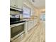 Kitchen featuring stainless steel appliances, light-colored cabinets, and modern floors at 409 Neathery St, Henderson, NC 27536
