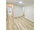 Bright living room featuring light-colored walls, new floors and doors to other rooms at 409 Neathery St, Henderson, NC 27536
