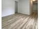 Bright Living Room featuring wood-look flooring and white walls at 409 Neathery St, Henderson, NC 27536