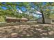 The brick home has a spacious backyard with mature trees and a car port at 419 Joy Dr, Garner, NC 27529