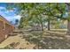 Spacious backyard with mature trees and a combination garage and car port at 419 Joy Dr, Garner, NC 27529