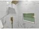 A shower features gold fixtures and marble-look tile with a green tile accent at 419 Joy Dr, Garner, NC 27529