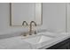 A bathroom features a black vanity, gold fixtures, and quartz countertops at 419 Joy Dr, Garner, NC 27529
