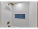 A shower features gold fixtures and white subway tile with a blue tile accent at 419 Joy Dr, Garner, NC 27529