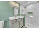 Beautiful bathroom featuring a modern vanity, a decorative mirror, and a luxurious tiled shower at 419 Joy Dr, Garner, NC 27529