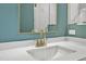 A bathroom features quartz countertops, a white sink and a gold faucet at 419 Joy Dr, Garner, NC 27529