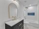 A bathroom features a black vanity, gold fixtures, and white subway tile in the shower at 419 Joy Dr, Garner, NC 27529