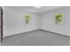 A bright bedroom features neutral carpet, two windows and white walls at 419 Joy Dr, Garner, NC 27529