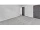 A bright bedroom features neutral carpet, neutral doors and white walls at 419 Joy Dr, Garner, NC 27529