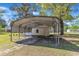 A metal car port sits next to a garage on this home's property at 419 Joy Dr, Garner, NC 27529