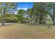 View of home from across the street with large front yard and mature trees at 419 Joy Dr, Garner, NC 27529