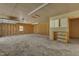 Unfinished garage featuring concrete floor and wood framing with fluorescent lighting at 419 Joy Dr, Garner, NC 27529