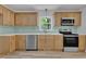 Bright kitchen features updated cabinets, stainless appliances, light countertops, and subway tile backsplash at 419 Joy Dr, Garner, NC 27529