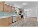 Modern kitchen with stainless steel appliances, light wood cabinets, and gorgeous tile backsplash at 419 Joy Dr, Garner, NC 27529