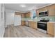 Modern kitchen with stainless appliances, bright cabinets, and backsplash, showcasing a sleek design at 419 Joy Dr, Garner, NC 27529
