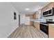 Spacious kitchen featuring stainless steel appliances, light wood cabinets, and modern flooring at 419 Joy Dr, Garner, NC 27529