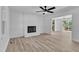 Bright living room with fireplace, wood-look flooring, and sliding glass door access to outdoor deck at 419 Joy Dr, Garner, NC 27529