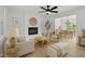 Bright living room featuring a fireplace, ceiling fan and an open floor plan leading to the dining area at 419 Joy Dr, Garner, NC 27529