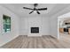 Cozy living room with fireplace, wood-look flooring, and open access to kitchen area at 419 Joy Dr, Garner, NC 27529
