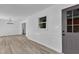 Open living room with new flooring, wainscoting, chandelier lighting, and an exterior door at 419 Joy Dr, Garner, NC 27529