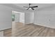 Bright open living room featuring wood-look flooring, neutral paint, and a ceiling fan at 419 Joy Dr, Garner, NC 27529