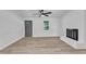 Bright open living room featuring wood-look flooring, fresh paint, and an exterior door at 419 Joy Dr, Garner, NC 27529