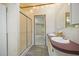 Bathroom with a double vanity, shower, and doorway leading to another room at 4500 Governor Hunt St, Efland, NC 27243