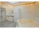 Bright bathroom featuring a double vanity, soaking tub, and linen closet at 4500 Governor Hunt St, Efland, NC 27243