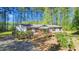 Charming one-story home features a sloped wooden ramp, complemented by lush landscaping and tall trees at 4500 Governor Hunt St, Efland, NC 27243