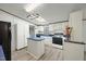 Well-equipped kitchen with modern appliances, skylight, white cabinetry, and a functional island at 4500 Governor Hunt St, Efland, NC 27243