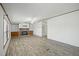 Spacious living room with a stone fireplace, wood-look floors, and ample natural light at 4500 Governor Hunt St, Efland, NC 27243