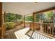 Spacious porch overlooking a lush, green yard with mature trees at 4500 Governor Hunt St, Efland, NC 27243