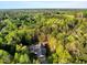 Overhead view of home surrounded by lush mature trees, emphasizing the property's secluded and peaceful setting at 452 Dogwood Trl, Henderson, NC 27537