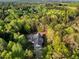 Aerial view of home surrounded by lush mature trees, emphasizing the property's secluded and peaceful setting at 452 Dogwood Trl, Henderson, NC 27537