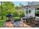 Relaxing back patio area with dining table, grill, brick pavers and landscaped garden at 452 Dogwood Trl, Henderson, NC 27537