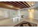 Finished basement space with exposed beams, a walkout to the exterior, and an area rug at 452 Dogwood Trl, Henderson, NC 27537