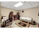 Spacious basement area with shelving, a tanning bed, concrete flooring, and a patterned area rug at 452 Dogwood Trl, Henderson, NC 27537