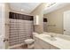 Cozy bathroom features patterned shower curtain, white vanity and a large mirror at 452 Dogwood Trl, Henderson, NC 27537