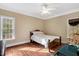 Cozy bedroom features hardwood floors, crown molding, and a view of the landscape at 452 Dogwood Trl, Henderson, NC 27537
