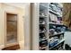 Walk-in closet offers extensive shelving and storage solutions next to a tiled shower at 452 Dogwood Trl, Henderson, NC 27537