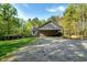 Single-story house with ample covered parking space and additional outbuilding on a spacious lot at 452 Dogwood Trl, Henderson, NC 27537