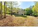 Well-maintained single story home with a spacious lawn and a detached shed, nestled among mature trees at 452 Dogwood Trl, Henderson, NC 27537