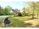 Inviting single story home with covered carport and an expertly landscaped stone and mulch garden at 452 Dogwood Trl, Henderson, NC 27537