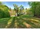 Expansive front yard with lush greenery and mature trees, showcasing the home's tranquil setting at 452 Dogwood Trl, Henderson, NC 27537